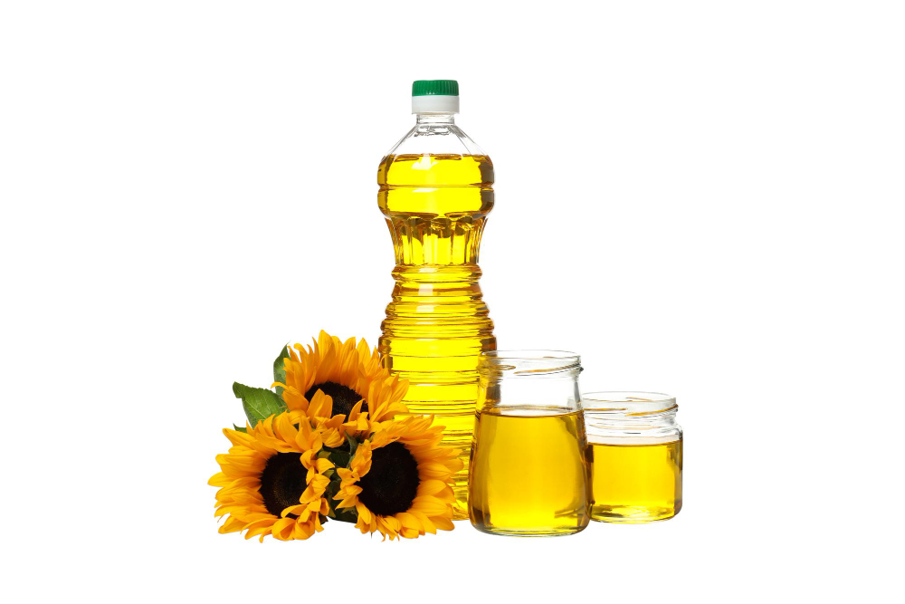 Sunflower oil with sunflowers in background – light and vitamin-rich Edible Oil